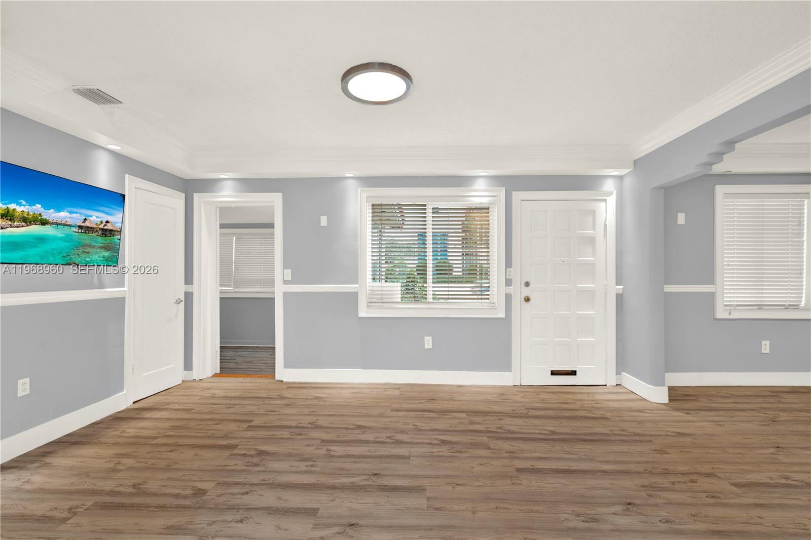 2001 Southwest 37th Avenue Miami, FL 33145 - Photo 3 of 31 a view of empty room with wooden floor and fan