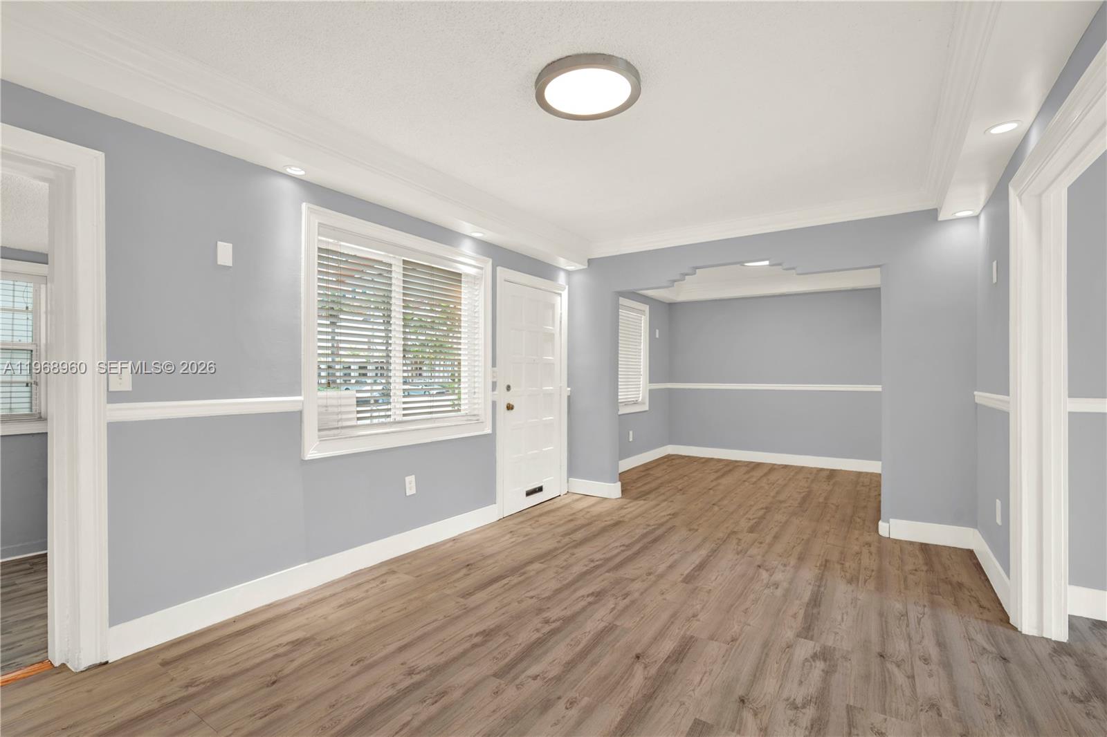 2001 Southwest 37th Avenue Miami, FL 33145 - Photo 4 of 31 a view of empty room with wooden floor and fan