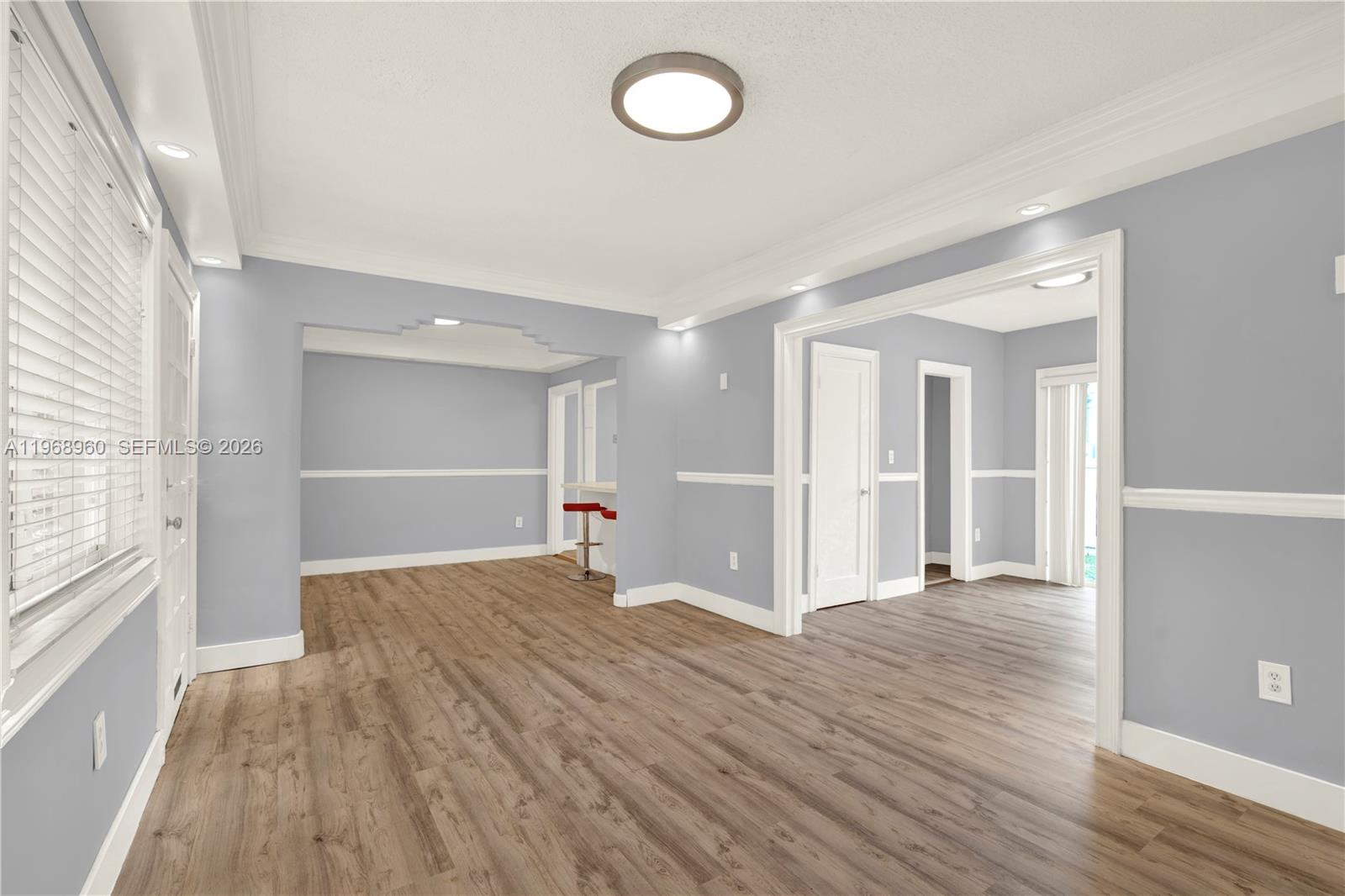 2001 Southwest 37th Avenue Miami, FL 33145 - Photo 5 of 31 a view of an empty room with wooden floor and a window