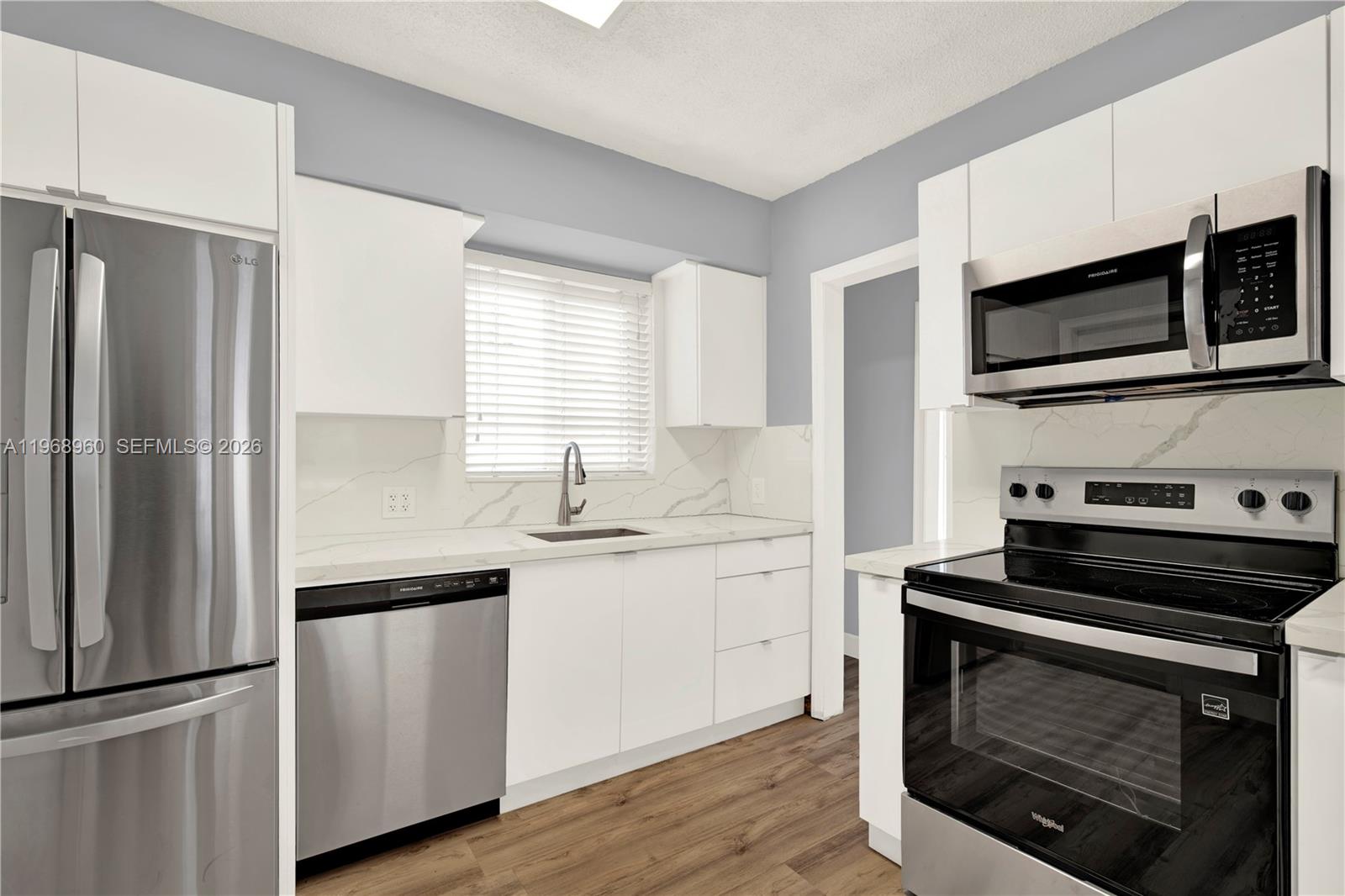 2001 Southwest 37th Avenue Miami, FL 33145 - Photo 9 of 31 a kitchen with stainless steel appliances a stove a microwave and a sink