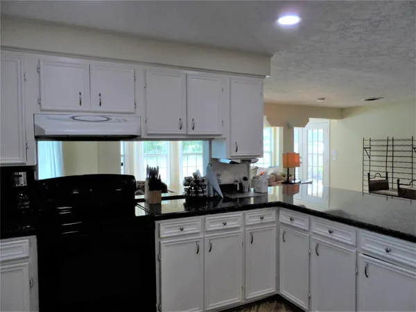 a kitchen with counter top space cabinets and appliances