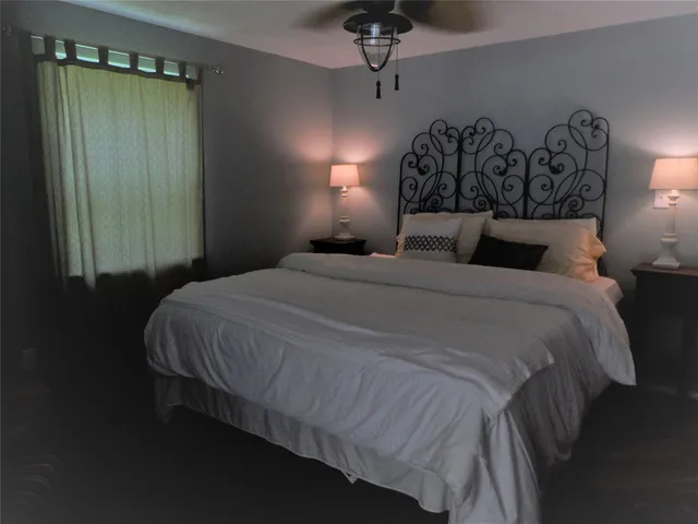 a bedroom with a bed and night stand