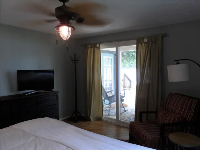 a bedroom with a large bed and a chandelier