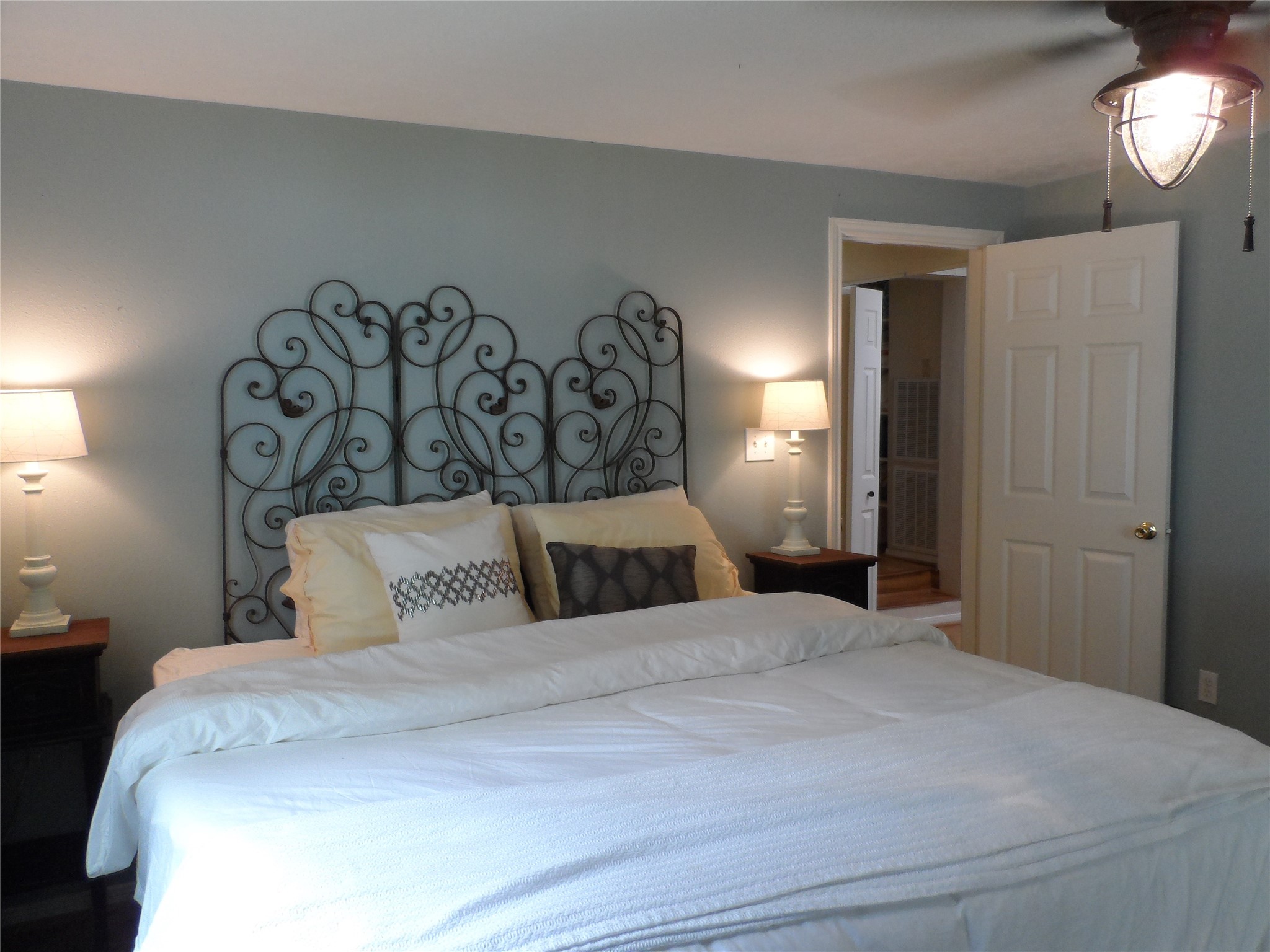 13545 Northshore Loop Conroe, TX 77304 - Photo 37 of 44 a bedroom with a large bed and a chandelier