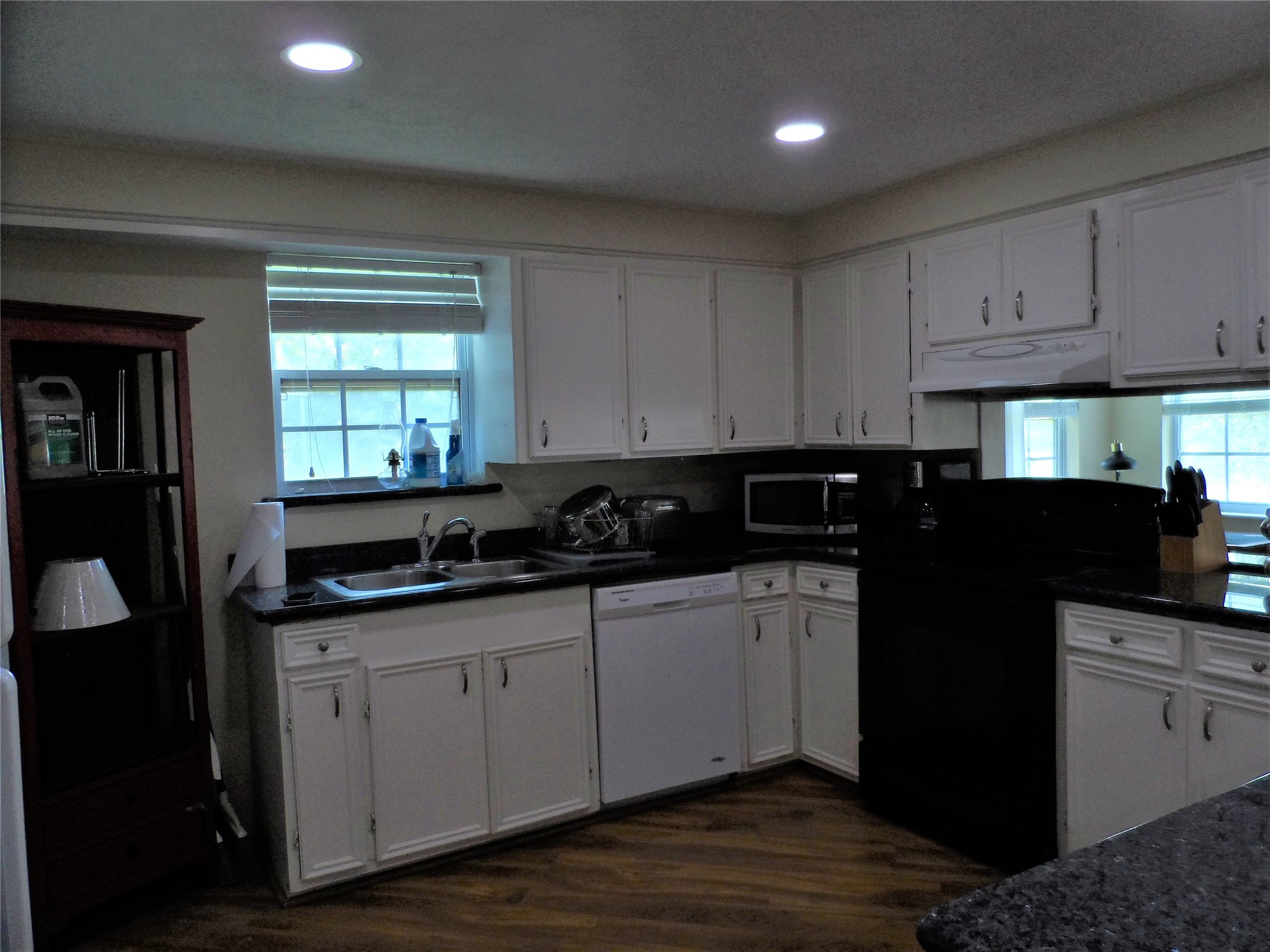 13545 Northshore Loop Conroe, TX 77304 - Photo 10 of 44 a kitchen with granite countertop a sink a stove cabinets and a refrigerator