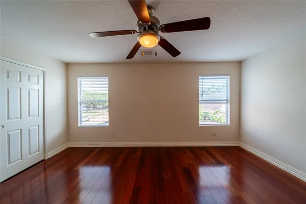 a view of a livingroom with a window and wooden floor