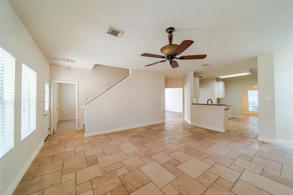 a view of a livingroom with a ceiling fan and window
