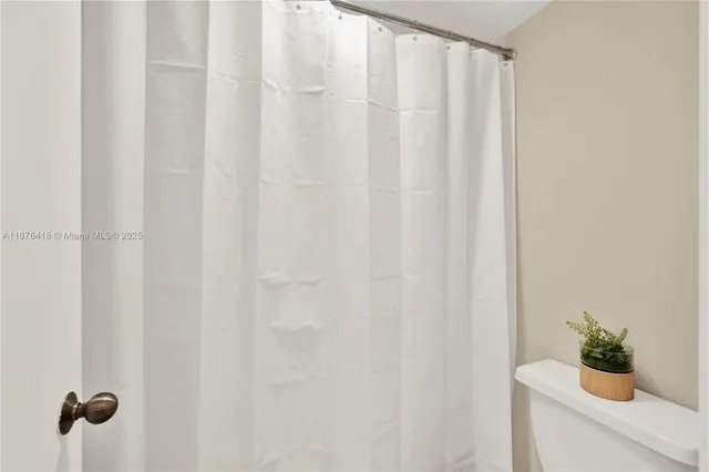 a bathroom with a shower curtain
