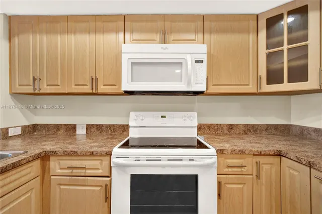a stove top oven sitting inside of a kitchen