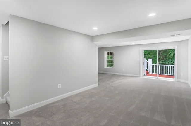 a view of a livingroom with an empty space and a window