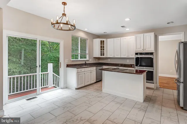 a kitchen with a stove a sink and a refrigerator