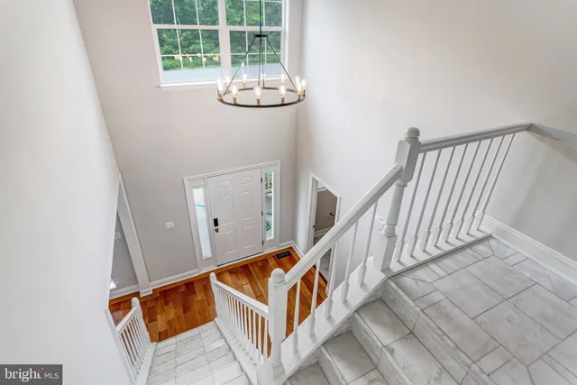 a view of staircase with white walls and window