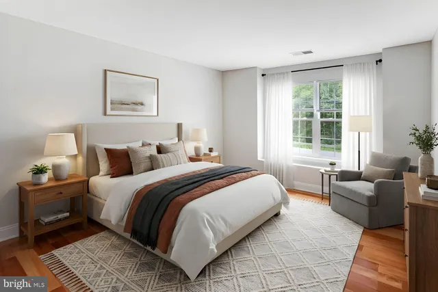 a bedroom with bed couch and window