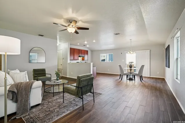 a living room with furniture and a wooden floor