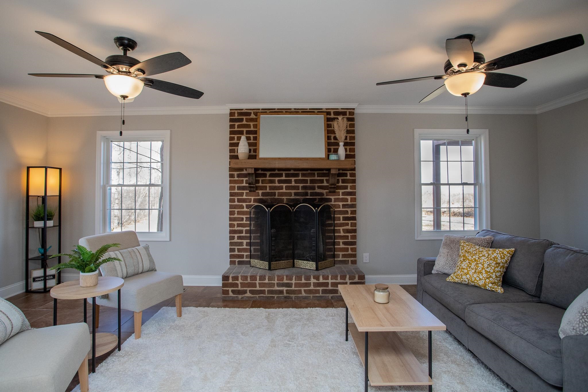 776 Chestnut Ridge Road Staunton, VA 24401 - Photo 15 of 73 a living room with furniture a chandelier and a fireplace
