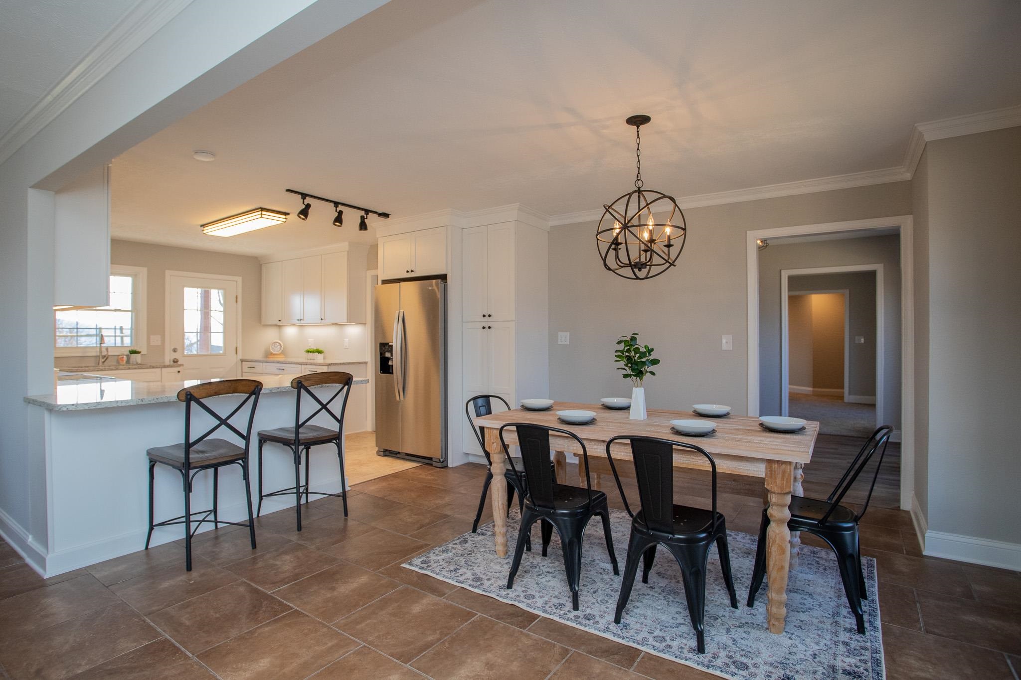 776 Chestnut Ridge Road Staunton, VA 24401 - Photo 20 of 73 a dining room with furniture a rug and a chandelier