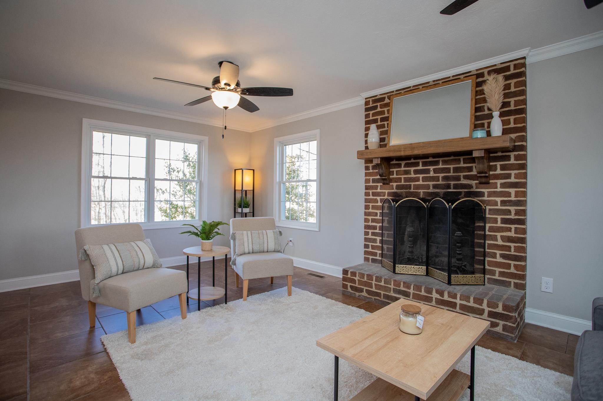 776 Chestnut Ridge Road Staunton, VA 24401 - Photo 35 of 73 a living room with furniture a fireplace and a table