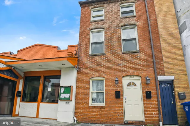 a view of a brick house with a large windows