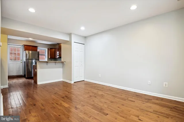 a kitchen with stainless steel appliances granite countertop a refrigerator a stove top oven a sink and dishwasher