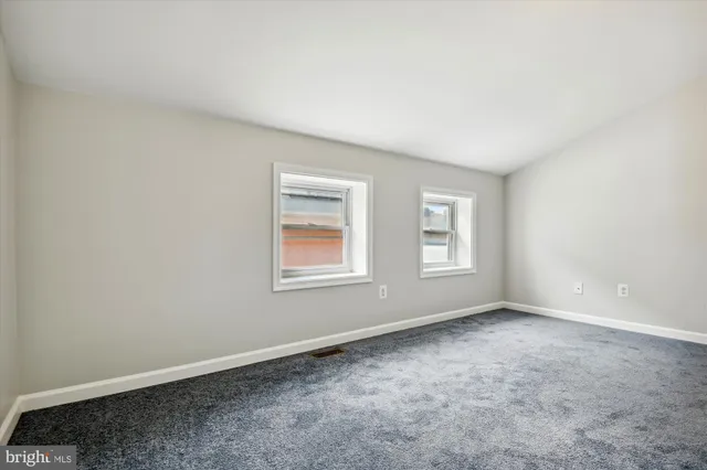 an empty room with a empty space and windows