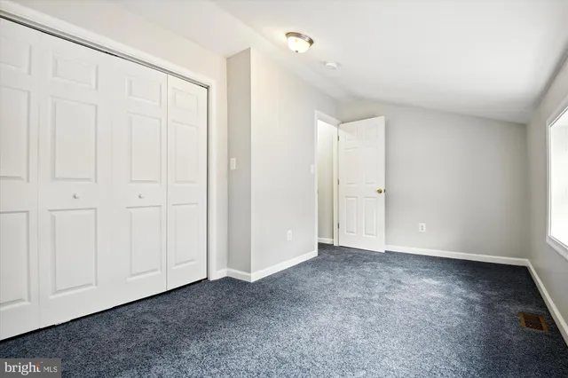 a view of a small space with wooden floor and a window