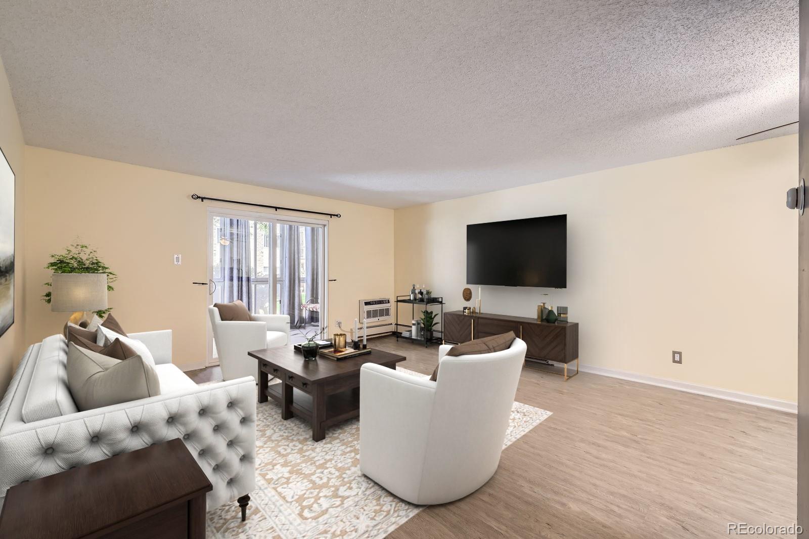 3124 South Wheeling Way, Unit 102 Aurora, CO 80014 - Photo 4 of 17 a living room with furniture and a flat screen tv