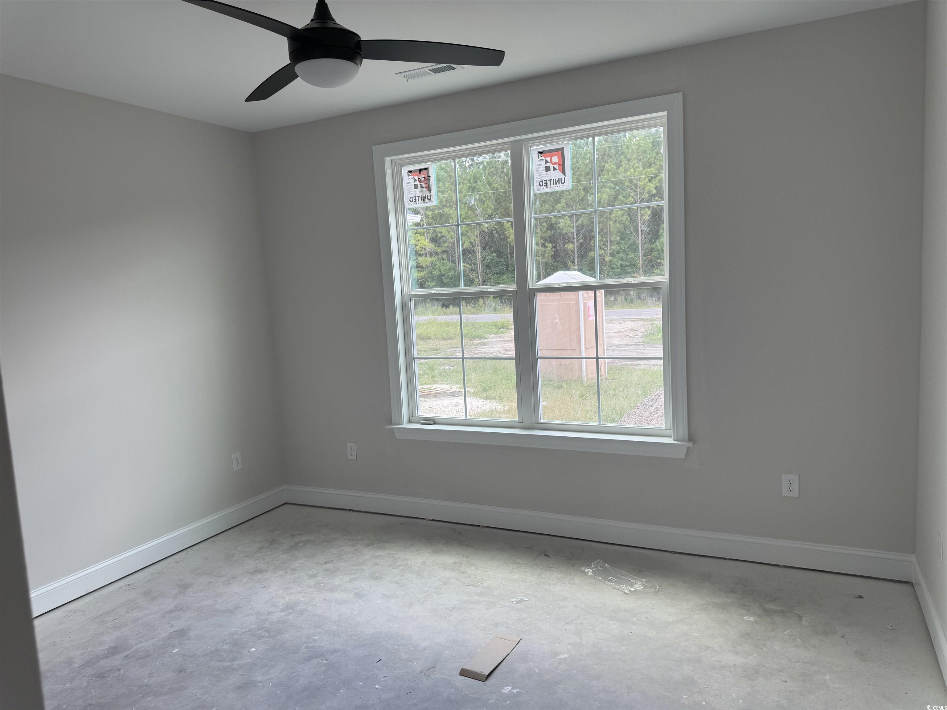 4971 Dupont Road Aynor, SC 29511 - Photo 11 of 12 Spare room with a ceiling fan and unfinished concrete flooring