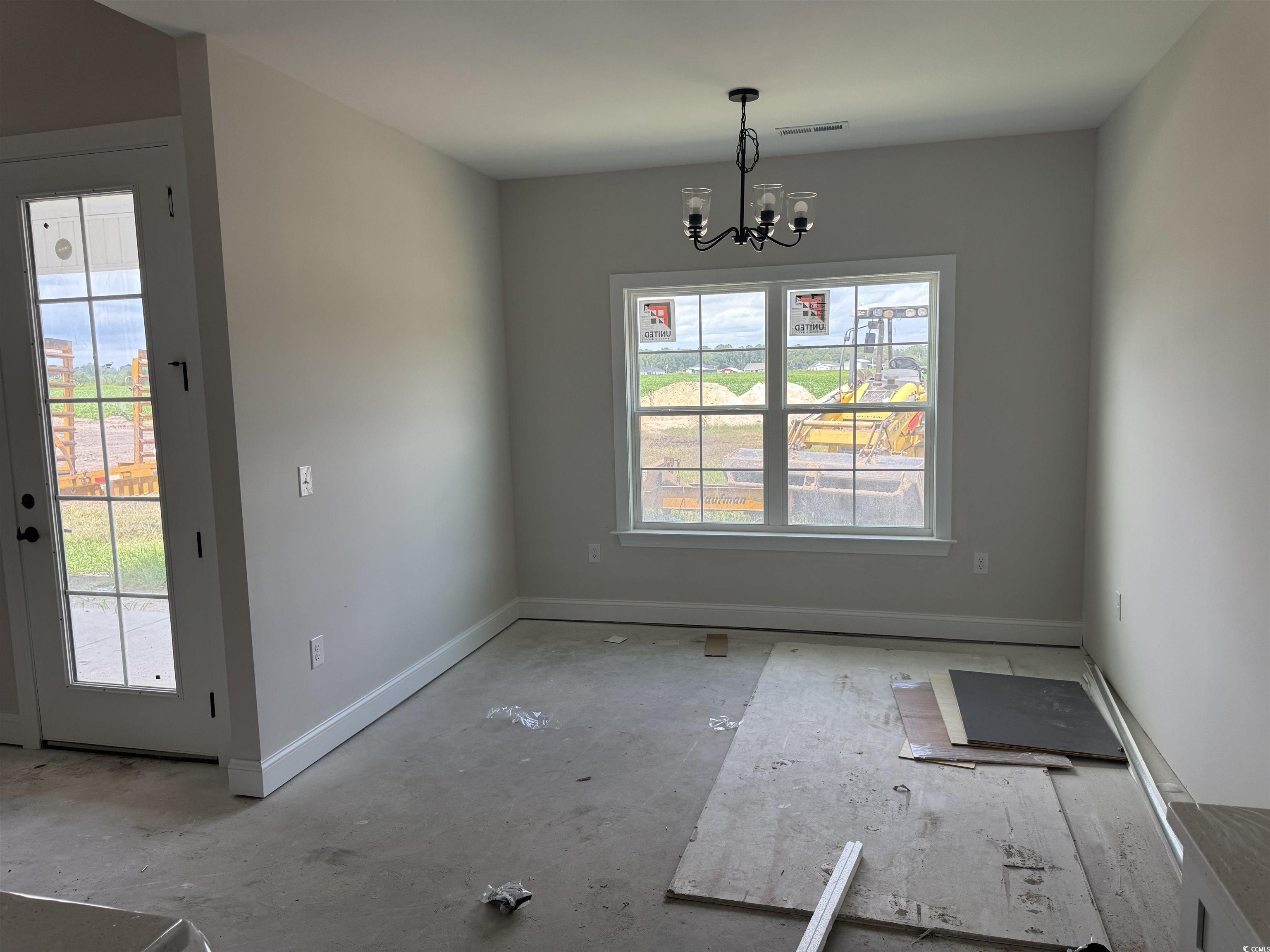 4971 Dupont Road Aynor, SC 29511 - Photo 5 of 12 Unfurnished dining area with baseboards and a chandelier