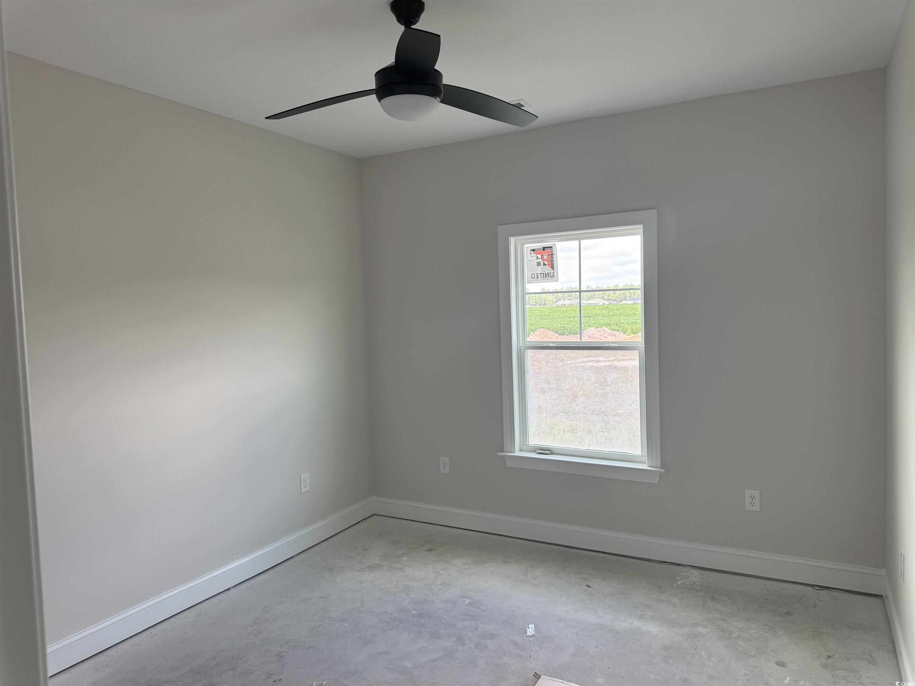 4971 Dupont Road Aynor, SC 29511 - Photo 9 of 12 Spare room with concrete floors and ceiling fan