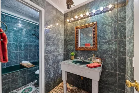 a bath tub sitting in a bathroom next to a sink