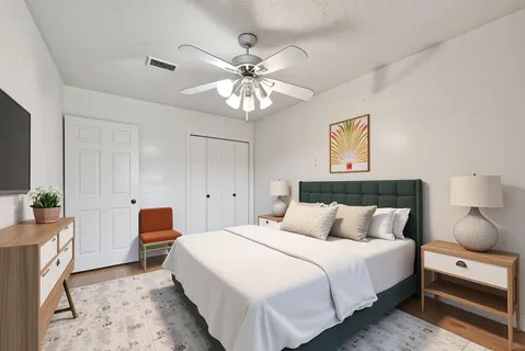 a bedroom with a bed and a chandelier