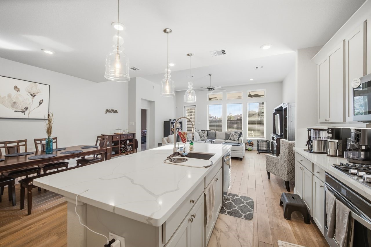 15326 Leal Rancho Court Cypress, TX 77433 - Photo 12 of 31 a kitchen with lots of counter space and painting on the wall