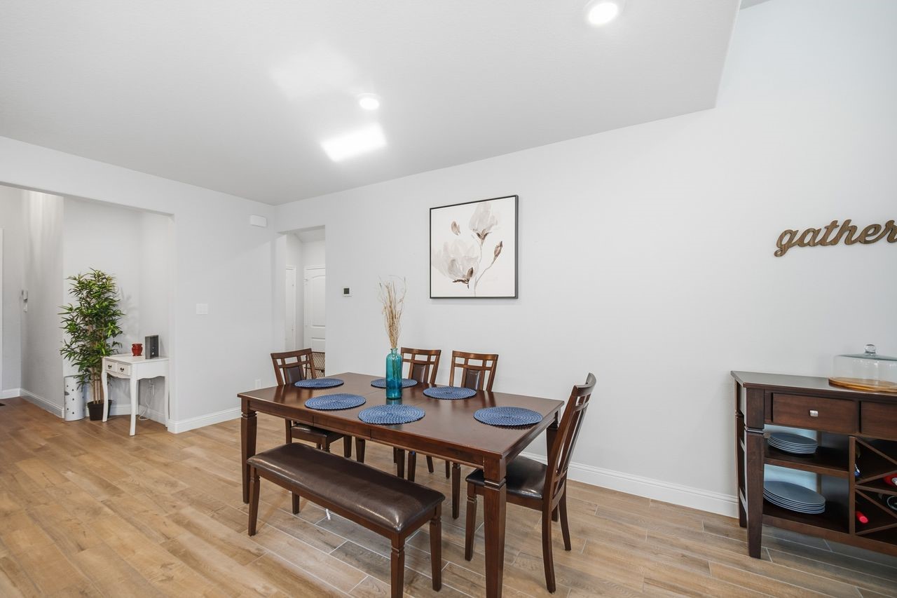15326 Leal Rancho Court Cypress, TX 77433 - Photo 14 of 31 a view of a dining room with furniture and wooden floor