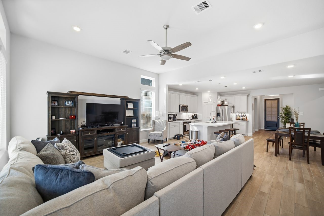 15326 Leal Rancho Court Cypress, TX 77433 - Photo 16 of 31 a living room with furniture and a flat screen tv