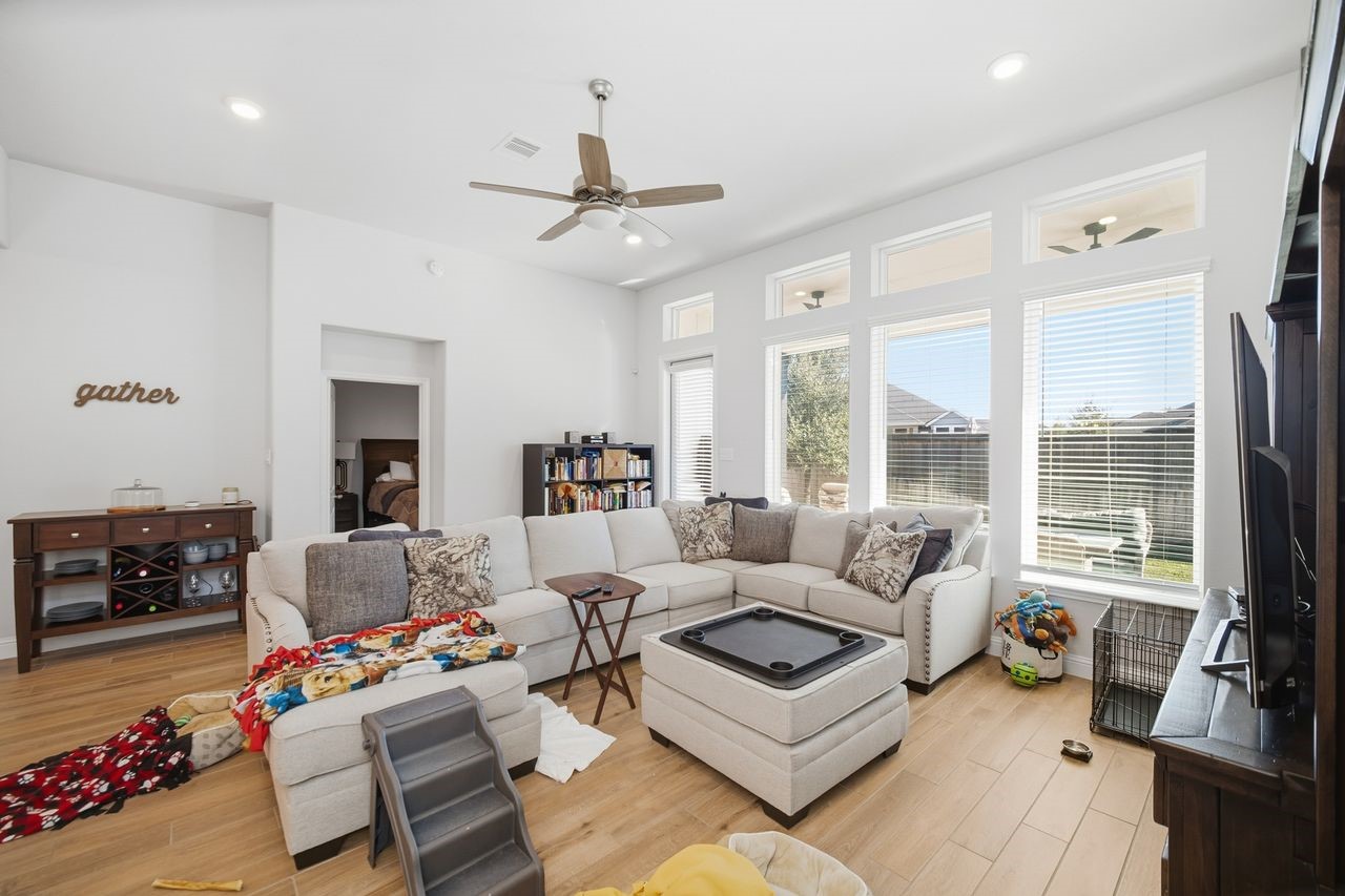 15326 Leal Rancho Court Cypress, TX 77433 - Photo 17 of 31 a living room with furniture and a large window