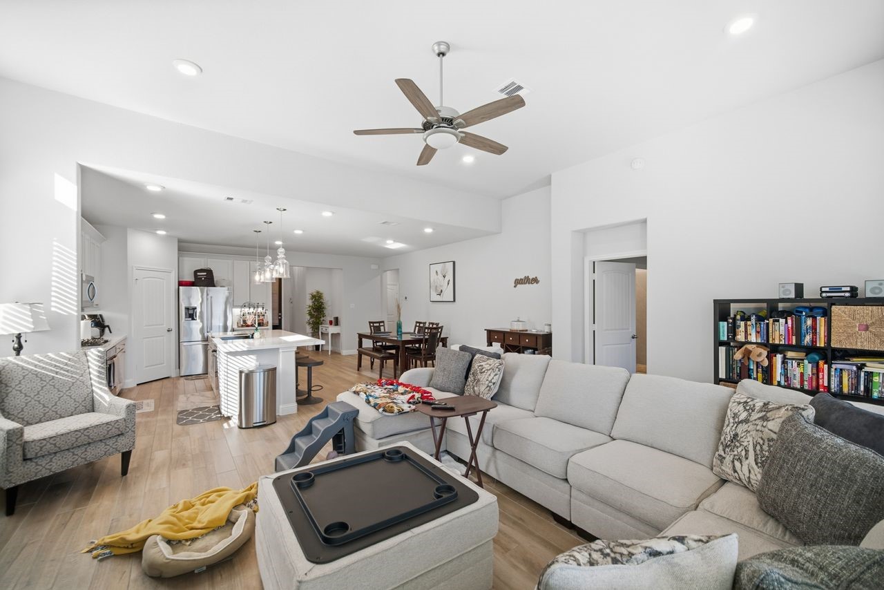 15326 Leal Rancho Court Cypress, TX 77433 - Photo 18 of 31 a living room with furniture and a book shelf