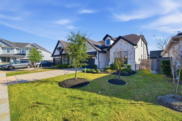 15326 Leal Rancho Court Cypress, TX 77433 - Photo 2 of 31 a front view of a house with garden