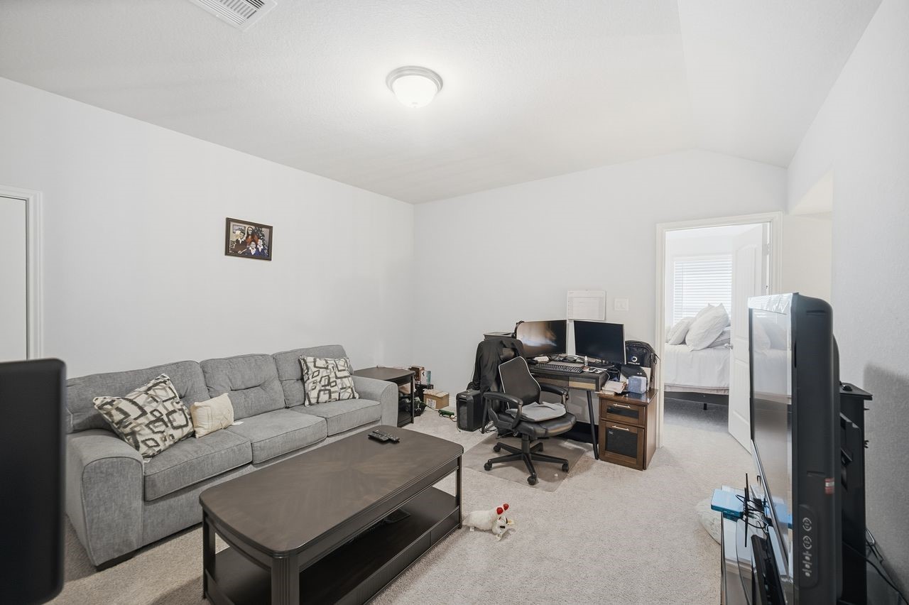 15326 Leal Rancho Court Cypress, TX 77433 - Photo 25 of 31 a living room with furniture and a flat screen tv