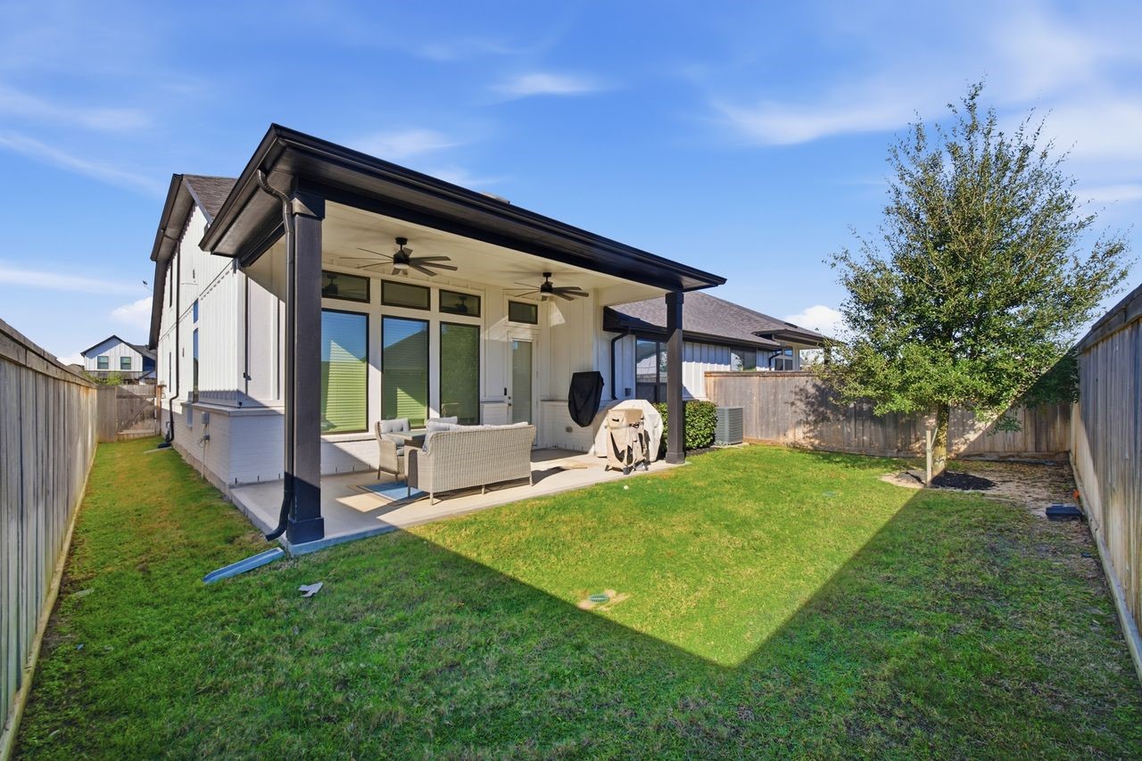 15326 Leal Rancho Court Cypress, TX 77433 - Photo 30 of 31 a view of a house with backyard and a patio