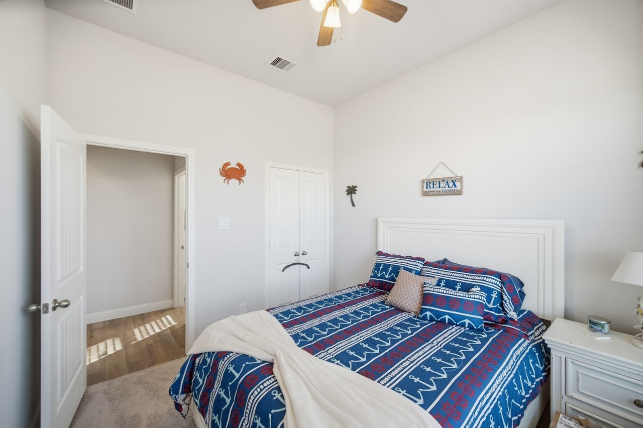 15326 Leal Rancho Court Cypress, TX 77433 - Photo 7 of 31 a bedroom with a bed and a lamp