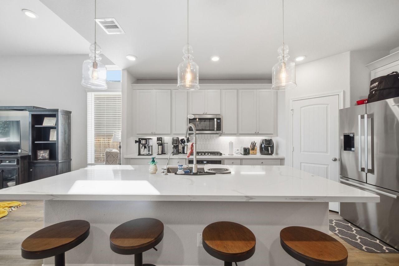 15326 Leal Rancho Court Cypress, TX 77433 - Photo 10 of 31 a kitchen with kitchen island a sink stove and refrigerator