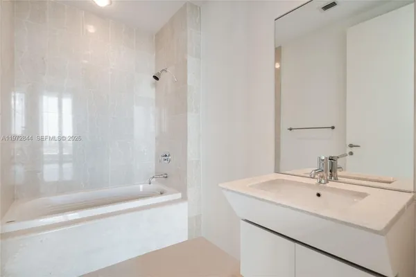 a bathroom with a bathtub and a sink