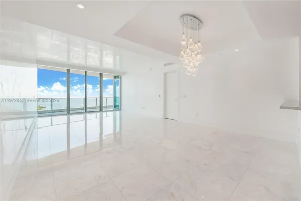 a view of a livingroom with a chandelier fan