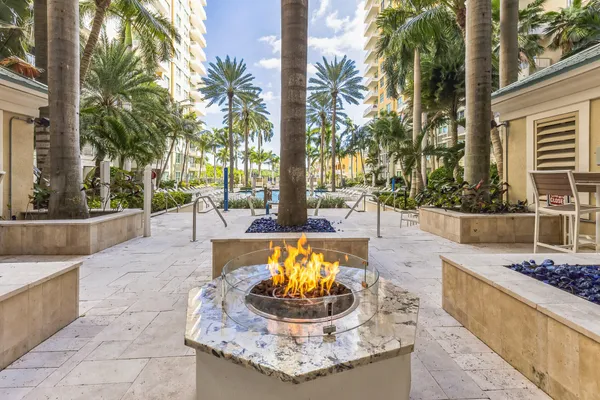 a swimming pool with outdoor seating and a patio