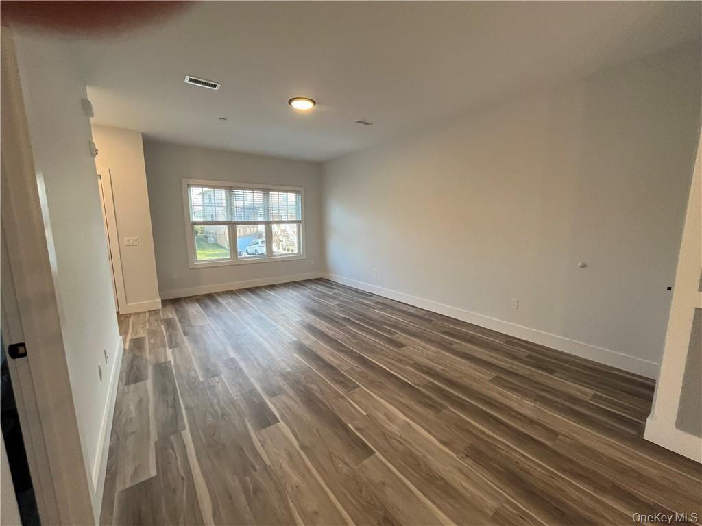 195 Park Avenue, Unit C West Harrison, NY 10604 - Photo 13 of 32 Unfurnished room featuring dark wood-type flooring and baseboards