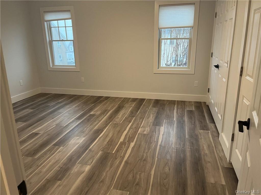 195 Park Avenue, Unit C West Harrison, NY 10604 - Photo 19 of 32 Spare room with dark wood-style floors and healthy amount of natural light