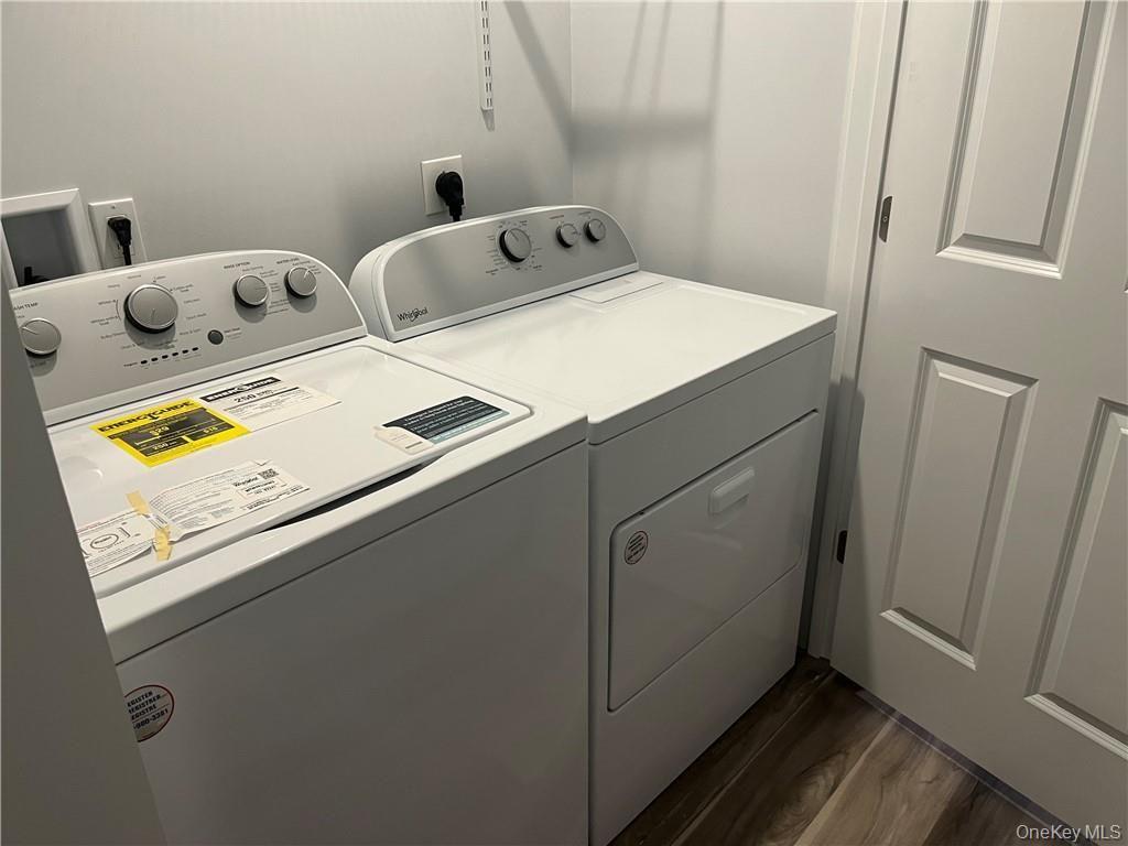 195 Park Avenue, Unit C West Harrison, NY 10604 - Photo 23 of 32 Laundry area with washer and clothes dryer and dark wood finished floors