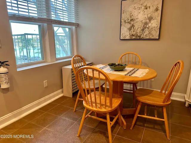 a view of a dining room with furniture and windows