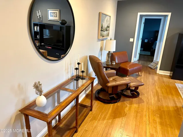 a balcony with furniture and a wooden floor