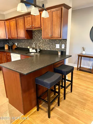 a kitchen with stainless steel appliances granite countertop a sink table and chairs in it